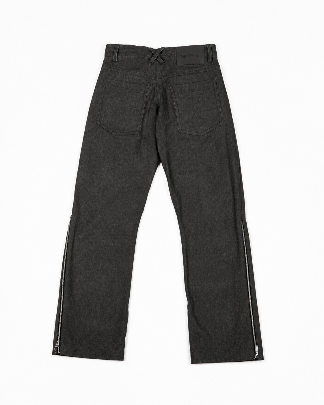 Back view of MINASEONG washed black wide-leg zip jeans laid flat