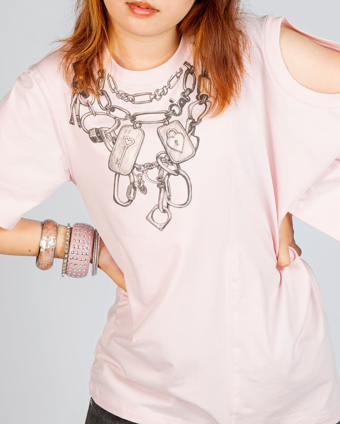 Close-up of chain and lock graphic on MINASEONG baby pink dual-neck T-shirt