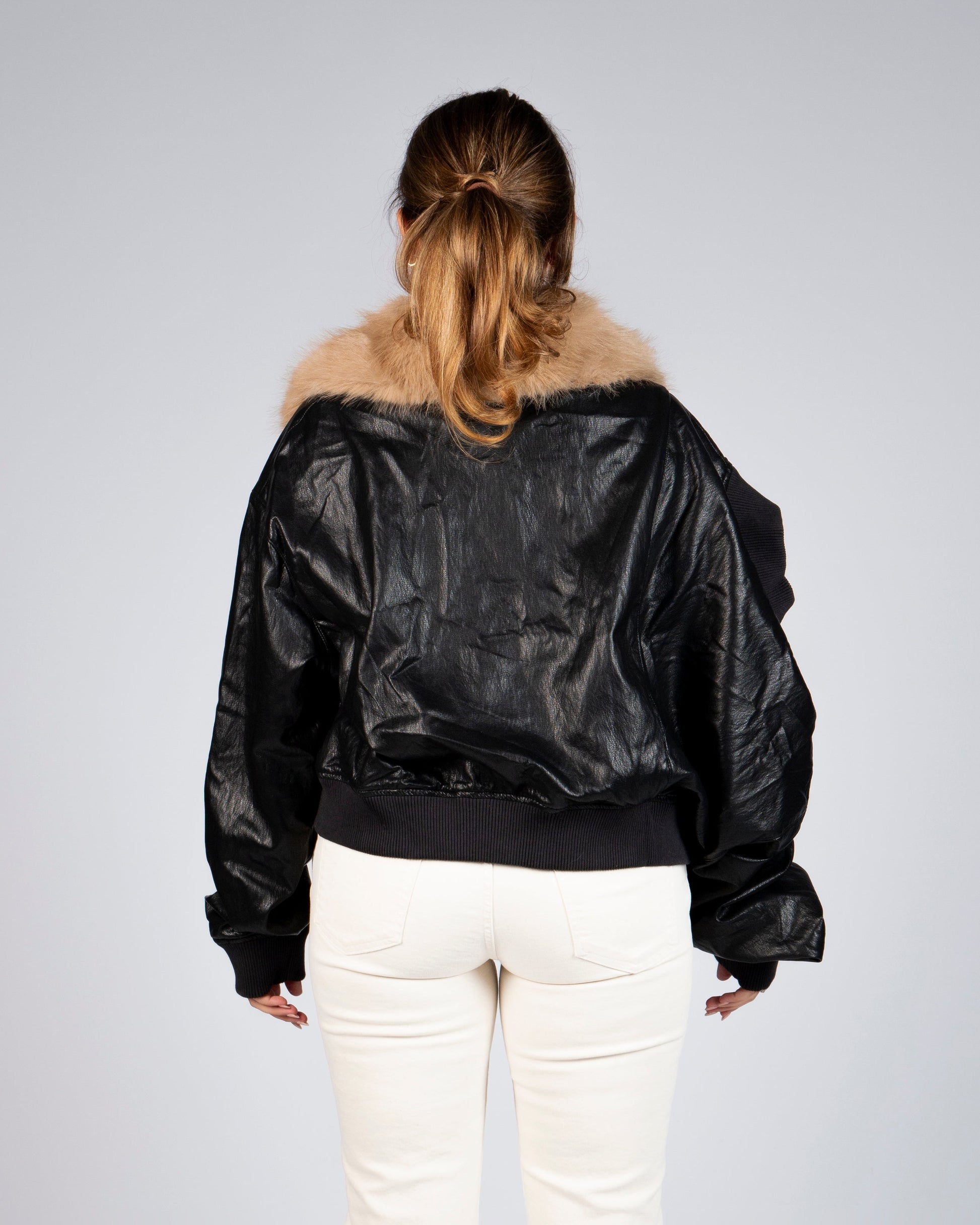 Back view of MINASEONG black faux leather bomber jacket with faux fur collar
