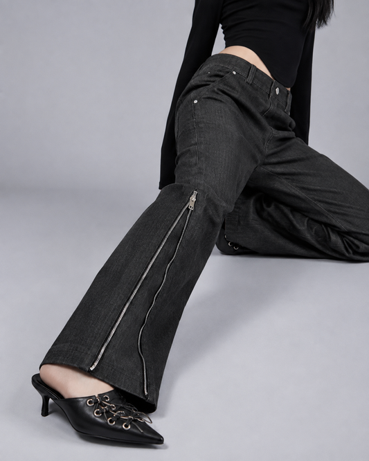 Close-up of MINASEONG washed black denim jeans with silver side zipper